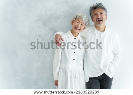 portrait of middle aged asian couple in white room