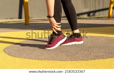 Athlete ankle pain, sports injury. Woman holding painful foot. Sprains, strains, fracture, tendonitis. Health problems concept. High quality photo Royalty-Free Stock Photo #2183523367