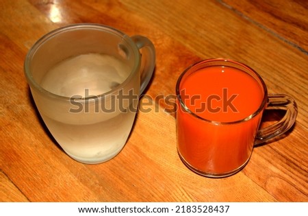 Glasses with water and fruit and vegetable juice on the table