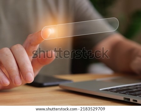 Searching concept with finger touching the search bar in virtual screen. Laptops is on wood table in work office or home.