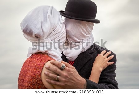 Faceless portrait of man kissing woman with white fabrics on their heads Royalty-Free Stock Photo #2183531003