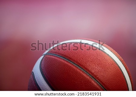 Professional basketball ball on the parquet with black background. Horizontal sport theme poster, greeting cards, headers, website and app
