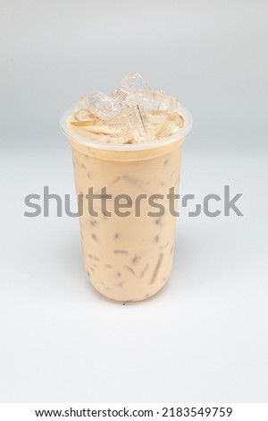 Thai style iced pink milk.Cold sweet drink Red Grenadien Sugar Syrup mix with milk and iced cube in glass isolated on white background with clipping path