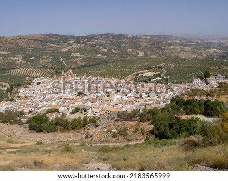 view of the historic center and the castle of the town of Zuheros in Córdoba and in the background a huge countryside of olive trees Royalty-Free Stock Photo #2183565999