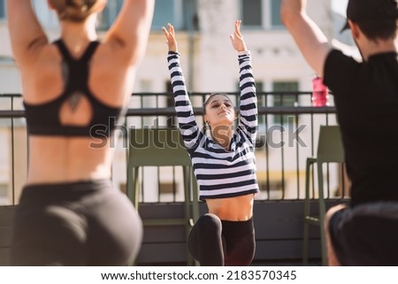 Yogi woman and diverse group of sporty people practicing yoga