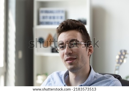 Portrait of caucasian young 20s man in eyeglasses, man looking in camera, feeling confident indoors, businessman or freelancer posing for photo, profile picture concept