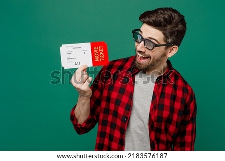 Young excited surprised amazed shocked fun cool cheerful caucasian man he in 3d glasses watch movie film hold look at ticket in cinema isolated on plain dark green color background studio portrait. Royalty-Free Stock Photo #2183576187