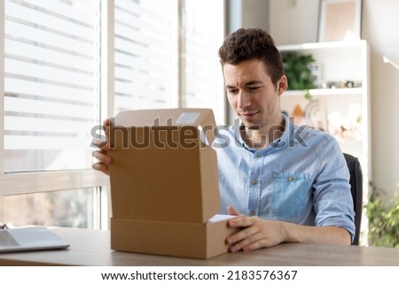 Shocked dissatisfied man customer open cardboard box receive damaged wrong parcel, disappointed male consumer having problem with bad fake online shop post shipping delivery order concept
 Royalty-Free Stock Photo #2183576367