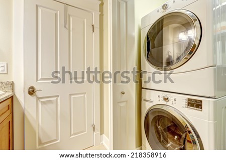 Laundry room with modern white appliances