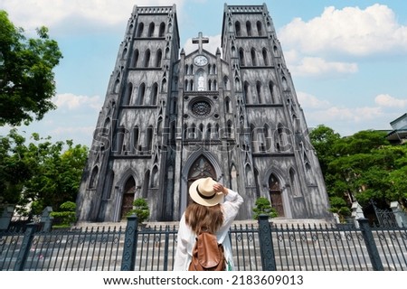 Woman traveller is sightseeing at St Joseph's Cathedral (Nha Tho Lon in Vietnamese) in Hanoi, Vietnam Royalty-Free Stock Photo #2183609013