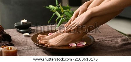 Young woman undergoing spa pedicure treatment in beauty salon Royalty-Free Stock Photo #2183613175