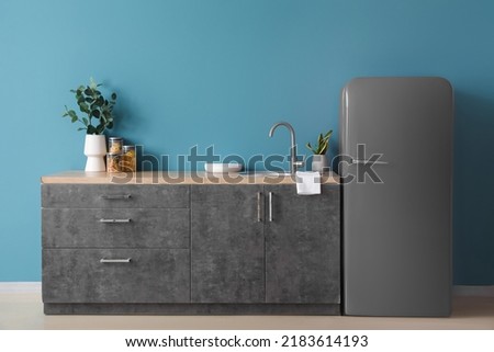 Grey fridge in interior of modern kitchen