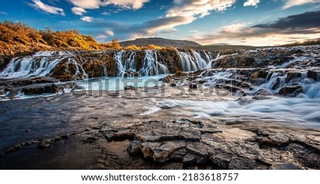 Scenic image of Iceland. Incredible nature landscape. Stunning view of Bruarfoss Waterfall. Azure water flows over stones. Bright midnight sun of Iceland. Iceland is a most popular place of travel. 