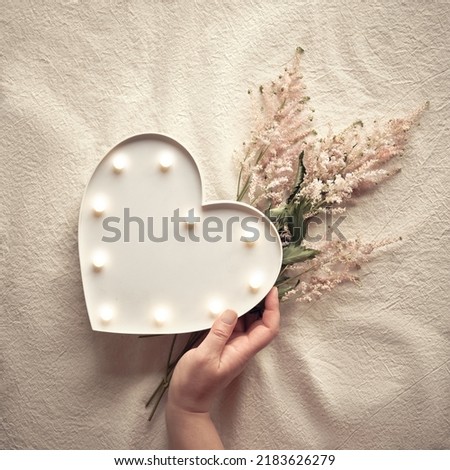 Coffee tones flowers. Heart lightbox and wild flowers . Flat lay on off white textile. Natural materials, environment concious, low impact, eco friendly boho lifestyle concept. Pale pink Prachtspiere