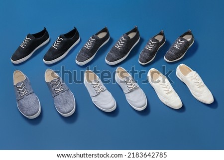 Stylish blue sneakers isolated on blue background, space for text