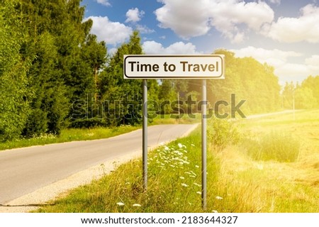 Time to Travel sign on the country road. Travel concept.