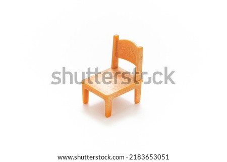 Kids chair isolated on white background. Kids toy. Simplicity. Play and learn. Kids room. Childhood. Kindergarten toy. Developmental toys. Doll house. Plastic chair.