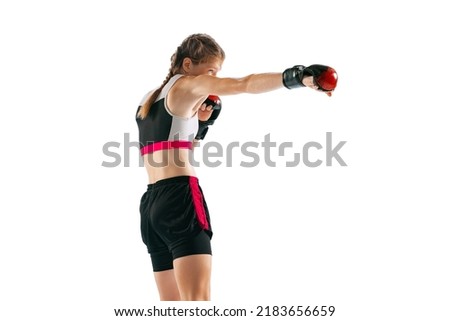Junior female MMA fighter in sports uniform and gloves training isolated on white background. Concept of sport, competition, action, healthy lifestyle. Copy space for ad.