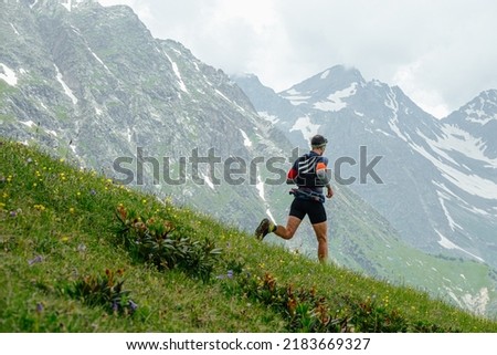 male trail runner running ultramarathon race Royalty-Free Stock Photo #2183669327