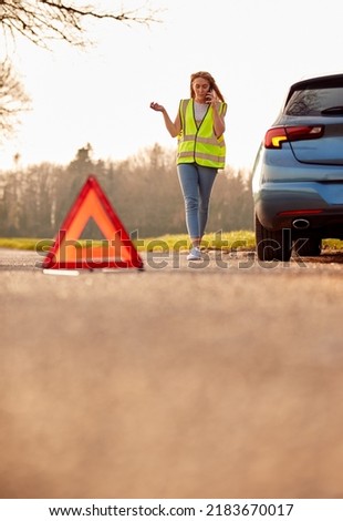 Hazard Warning Triangle Sign For Car Breakdown On Road With Woman Calling For Help I