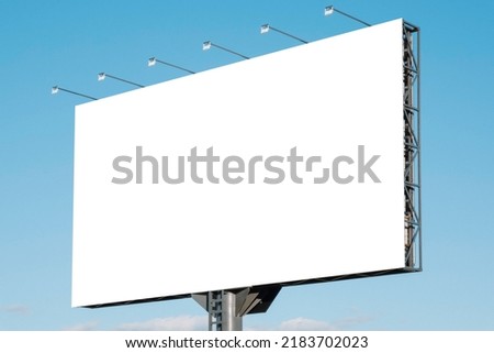 Large white blank billboard for outdoor advertisement, information board on blue sky background