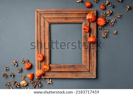 Autumn leaves are red and orange. composition with a wooden frame for the image. copy space, flat lay
