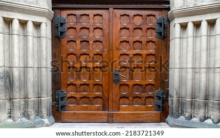 Large medieval church door with metal handle Royalty-Free Stock Photo #2183721349