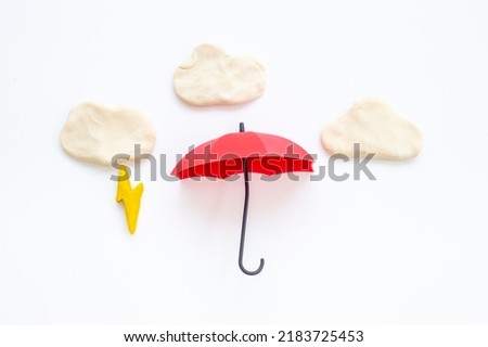 Plasticine clouds with lightning thunderbolt. Weather forecast concept