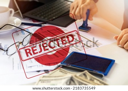 Businessman signing a business project rejection stamp,Documents not reviewed,reject investment projects