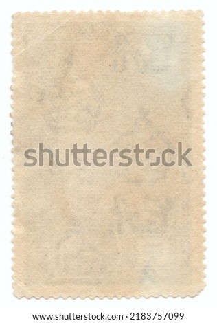 Vintage paper texture for design. Reverse of original old postage stamp with crown type watermarks and perforations