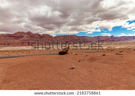 The mountain range seen behind the giant boulder - beautiful clouds, Vermillion cliff range, Page, AZ, USA