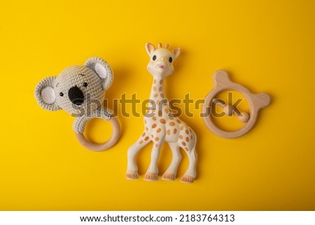 Rattle toys for baby on a yellow background.