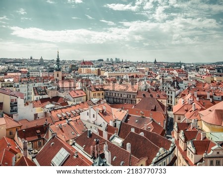  Beautiful aerial view with the city of Prague. Many traditional houses with red roof tiles.