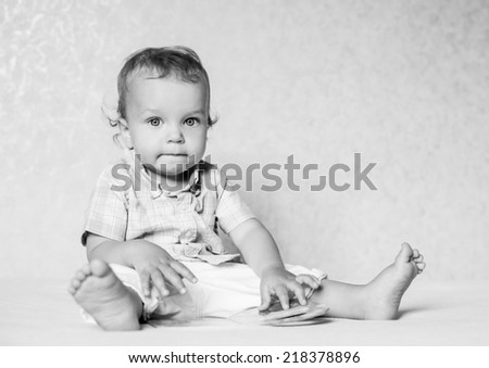 portrait toddler boy sitting considering the book ( black and white )