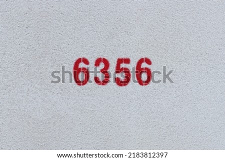 Red Number 6356 on the white wall. Spray paint.
