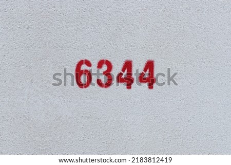 Red Number 6344 on the white wall. Spray paint.
