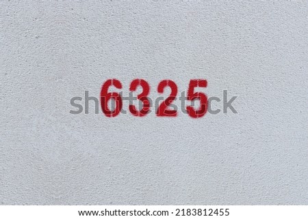Red Number 6325 on the white wall. Spray paint.
