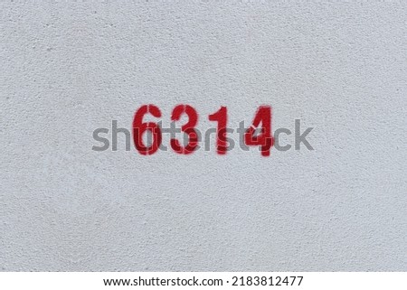 Red Number 6314 on the white wall. Spray paint.
