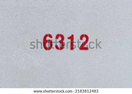 Red Number 6312 on the white wall. Spray paint.
