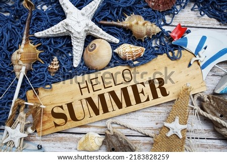 Hello Summer text message decoration with seashell and marine on wooden background