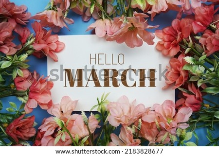Hello March text message with flower decoration on blue background