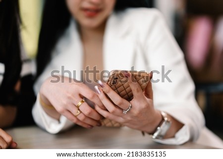 Woman using app on phone to communicate at café, Close-up of her hands. Lifestyle and Technology