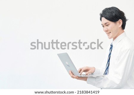 Asian worker using the laptop in white background