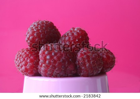 Front view of raspberries, on a pink background. Clipping path included. Royalty-Free Stock Photo #2183842