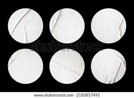 Collection of blank glued sticker mockup design. Realistic round stickers in wrinkled surface style. Adhesive paper on black background. Blank copy space for tape, label, badge and creative design. Royalty-Free Stock Photo #2183857495