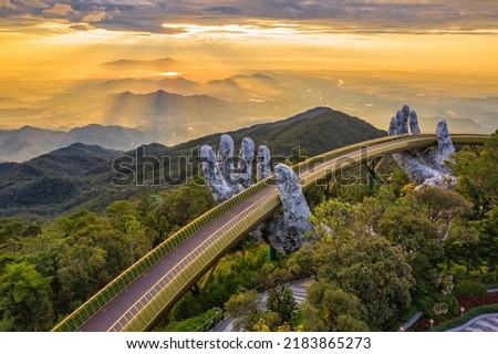 Aerial view of the Golden Bridge is lifted by two giant hands in the tourist resort on Ba Na Hill in Da Nang, Vietnam. Ba Na mountain resort is a favorite destination for tourists Royalty-Free Stock Photo #2183865273
