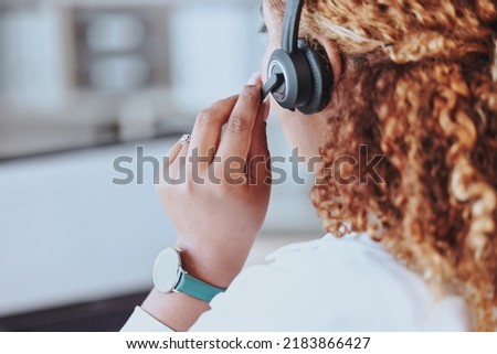 Talking, advice, discussion being had by a call center agent wearing a headset in an office at work. Customer service, support and conversation given to a client from a female working at a startup Royalty-Free Stock Photo #2183866427