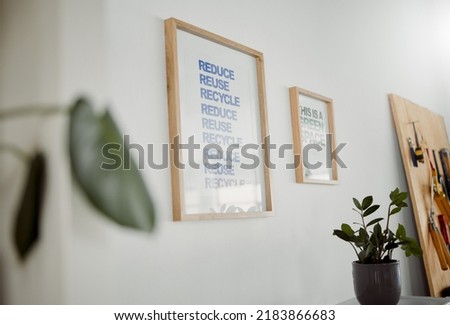 Environmental conservation for a sustainable and green ecosystem and eco friendly world. Reduce, reuse and recycle poster hanging in an office as a mantra to conserve, protect and save planet earth
