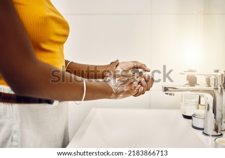 Woman washing, cleaning and rubbing hands with soap and water for good personal hygiene, safety and health in a bathroom at home. Killing germs, virus and bacteria to prevent the spread of infection Royalty-Free Stock Photo #2183866713