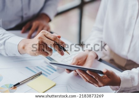 The financiers are calculating personal taxes for their customers. Royalty-Free Stock Photo #2183873269